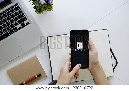 Chiang Mai,thailand - Feb 18, 2018 : A Woman Hand Holding Uber App Showing On New Mobile Samsung Gal