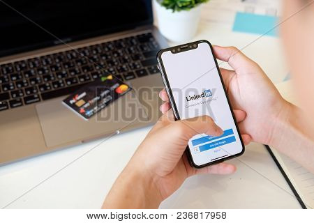 Chiangmai,thailand 22 Feb 2018 : Man Holding New Iphone X On Hand Open Linkedin Application On The S