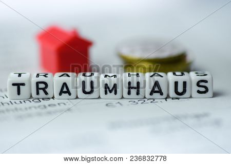 German Word Dreamhouse Formed By Alphabet Blocks: Traumhaus Real Estate Business
