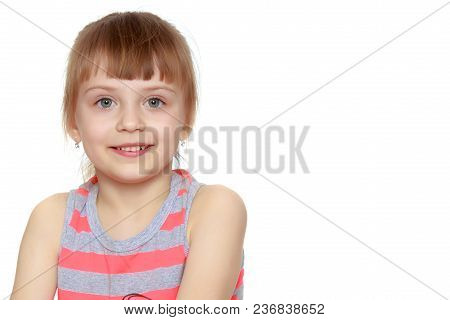 Beautiful Little Caucasian Girl With A Short Bangs And Hair Tucked Into A Tail. In Striped In A T-sh