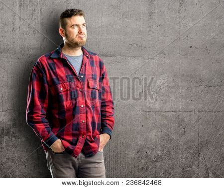 Young handsome man making funny face fooling