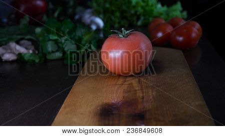 Kitchen Table With Vegetables, Tomato, Red Pepper, Ginger, Green Salad, Champignons And Knife.