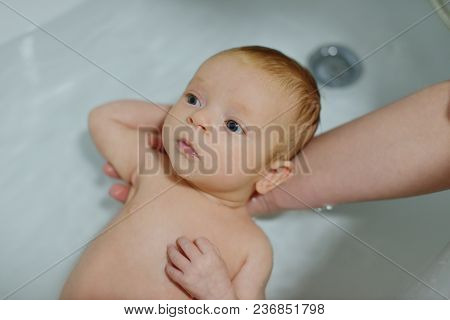 Woman  Holding Her Newborn Baby In The Water