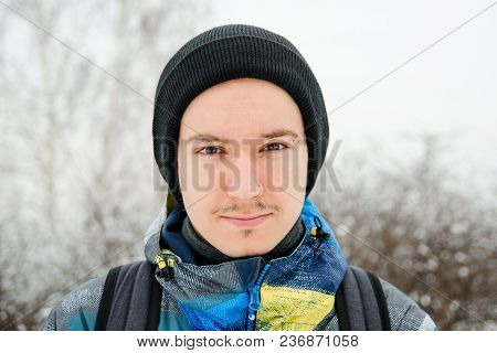 Close Up Portrait Of Young Guy In Hat On Trees Blur Background
