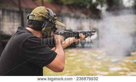 Man Shooting On An Outdoor Shooting Range, Selective Focus