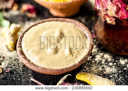 Ayurvedic Ubtan Of Haldi With Holy Rose Water And Fuller’s Earth On Wooden Surface For Good, Brighte