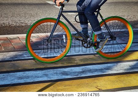 A Cyclist In The City Goes On A Pedestrian Crossing. Eco-friendly Mode Of Transport