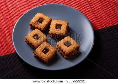 Chocolate Sand Chip Cookies Stacked Up On A Plate, Ready To Be Served.