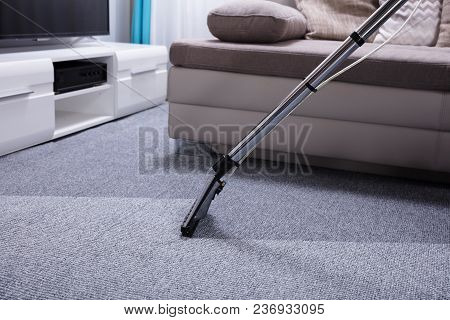 Close-up Of A Vacuum Cleaner Over Grey Carpet