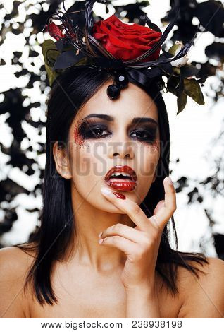 Pretty Brunette Woman With Rose Jewelry, Black And Red, Bright Make Up Kike A Vampire Closeup