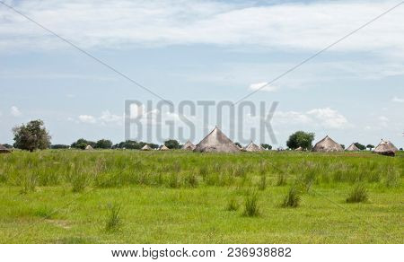 Village with grass huts on the plains of South Sudan.