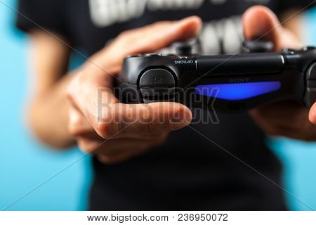 Male hands holding a PS4 controller