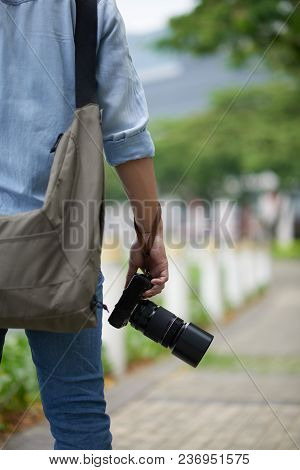 Cropped Image Of Man With Professonal Digital Camera Standing Outdoors