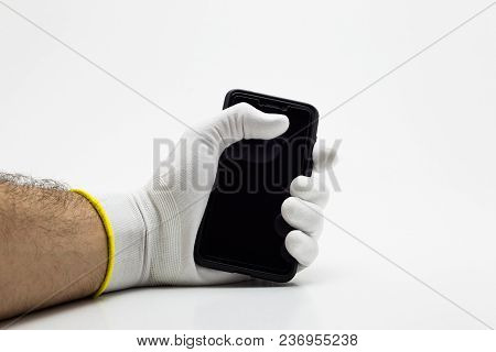 Smartphone In A Tight Hand In White Glove On White Background Isolation