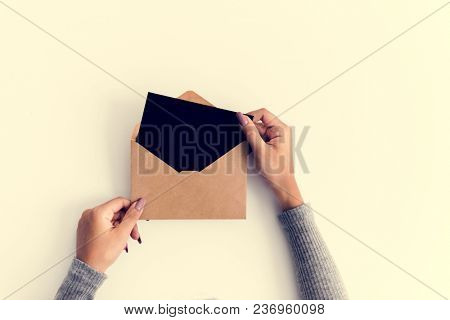 Woman hands holding envolope on white background