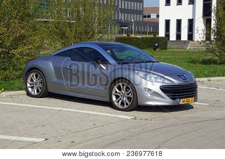 Almere, Flevoland, The Netherlands - March 17, 2018: Grey Peugeot Rcz Coupe Parked On Parked On A Pu