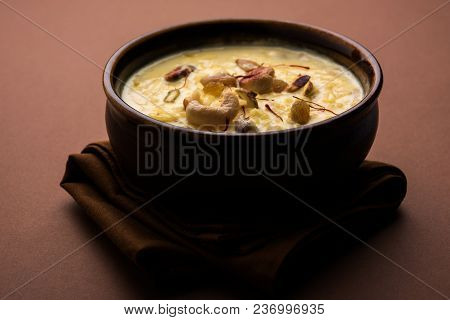 Kheer Or Rice Pudding Is An Indian Dessert In A Brown Terracotta Bowl With Dry Fruits Toppings