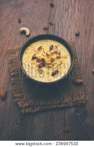 Kheer Or Rice Pudding Is An Indian Dessert In A Brown Terracotta Bowl With Dry Fruits Toppings