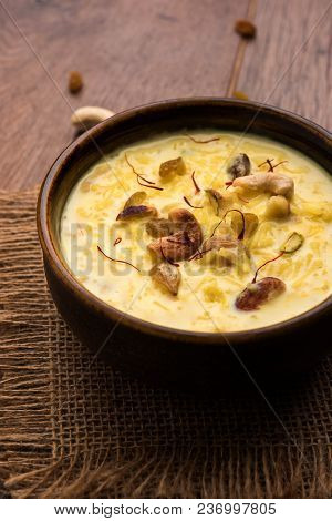 Kheer Or Rice Pudding Is An Indian Dessert In A Brown Terracotta Bowl With Dry Fruits Toppings
