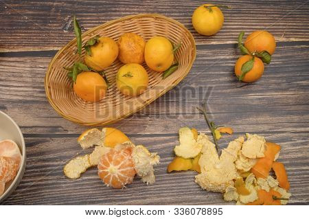 Peeled Tangerines In A Ceramic Dish, Tangerines On A Twig With Green Leaves, Tangerine Peel On A Woo