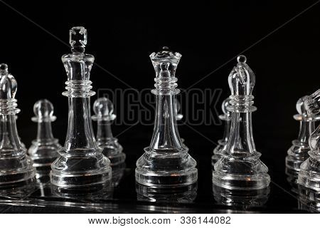 Transparent Methacrylate Chess Pieces, Front View Placed On A Black Background.
All The Pieces Of A 
