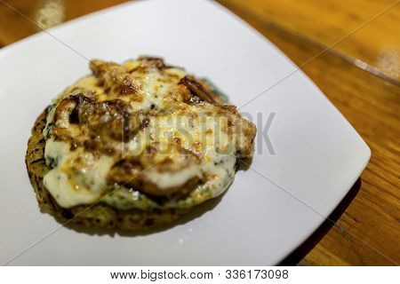 Potato Rosti Seafood Fish Cake With Mozarella, Dill And Salted Herring In Plate