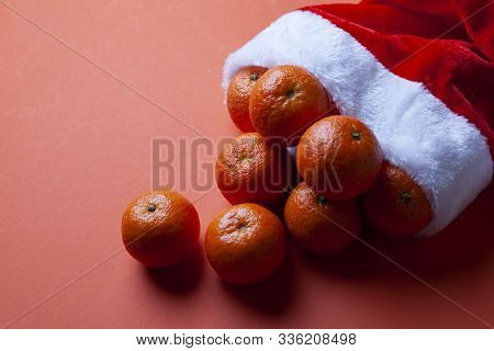 Christmas Tangerines In A Santa Hat On An Orange Background, Christmas Fruits, Festive Symbol