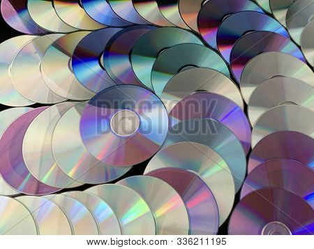 Background Texture: A Lot Of Computer Disks. Music Cds On A Black Background, Abstraction. Concept: