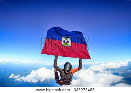 Haiti Extreme. Flag In Skydiving. People In Free Fall Grab Flag Of Haiti. Patriotism, Men And Flag.