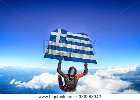 Greece Extreme. Flag In Skydiving. People In Free Fall Grab Flag Of Greece. Patriotism, Men And Flag