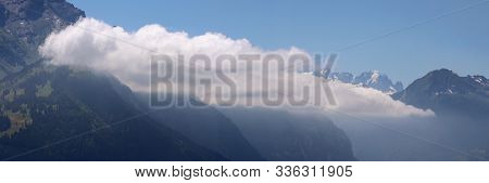 View Of Clouds Moving Along A Mountain Slope In Summer