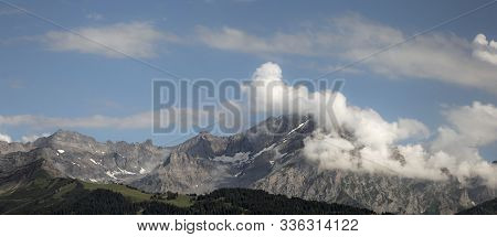Alpine Landscape With Mountain And Clouds In Summer