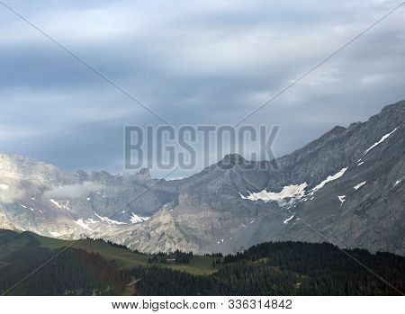 Alpine Scenery With Forest Ridge And Mountain