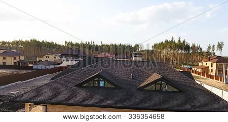 House With A Roof From A Bituminous Tile. Bituminous Tile For A Roof. A Roof From A Bituminous Tile.