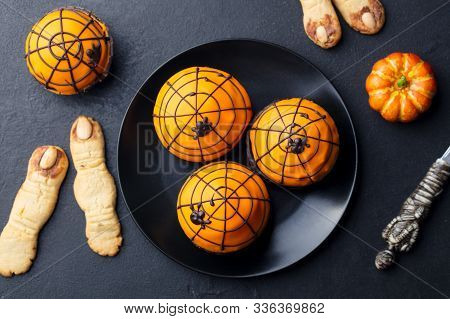 Halloween Cupcakes With Witches Fingers Cookies. Black Slate Background. Top View