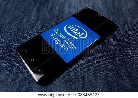 Odessa, Ukraine - October 26, 2019: Intel App. Intel Logo Visible On Smartphone Screen. Denim Backgr