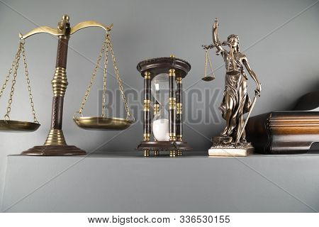 Judge And Justice Concept. Themis Statue, Scale And Hourglass On Off-white Background.