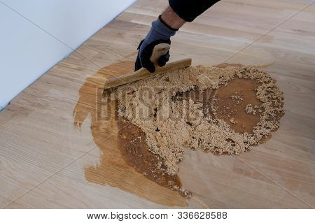 Master Parquet With Spatula In Your Hand. Preparation Of Parquet Grout Material. Mixing Retainer, Va