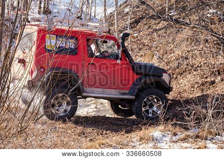 Khabarovsk, Russia - Nov 11, 2019: Jeep Suzuki Jimny Overcomes Obstacles In The Forest.