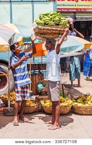 Colombo, Sri Lanka - March 16th 2011: Man Carrying Bananas In A Basket On His Head In The Pettah Dis