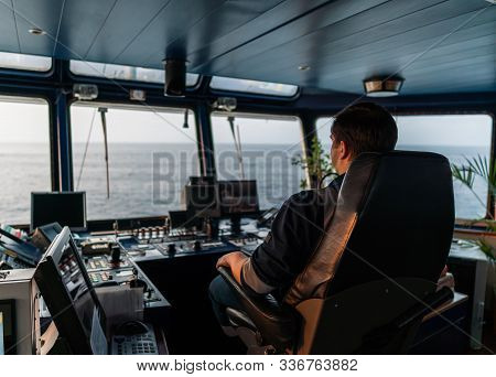 Marine Navigational Officer During Navigational Watch On Bridge . Work At Sea