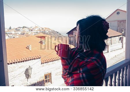 Woman On Balcony With Coffee At Home