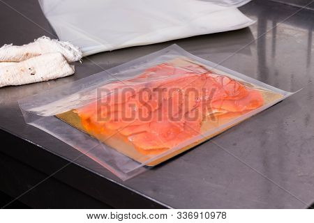 Fish Production. Sliced Pieces Of Fish Lies In The Package For Further Sealing