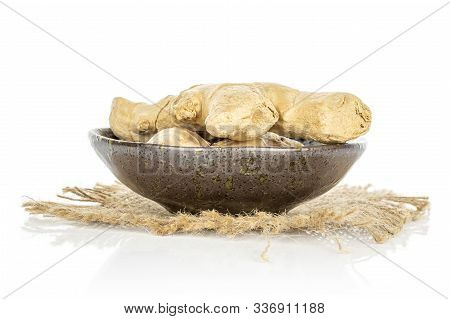 Group Of Two Whole Fresh Brown Ginger In Glazed Bowl With Jute Fabric Isolated On White Background