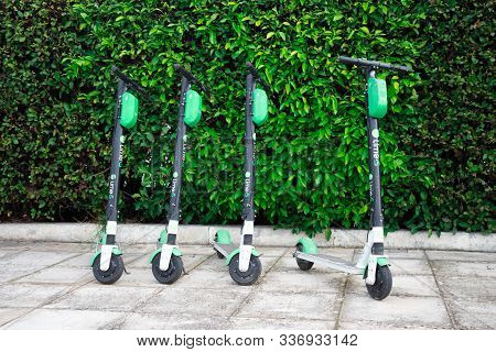 Greece, Athens - November 30, 2019: Parked Lime S Scooters On The Road Near The Bushes