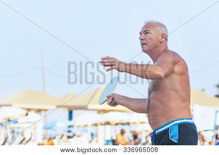 Adult Male Playing Matkot On The Beach