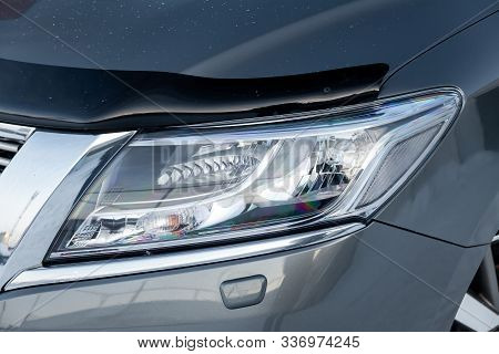 Front Headlamp View Of Gray Used Car Stands In The Auto Showroom Sale After Washing And Polish With 