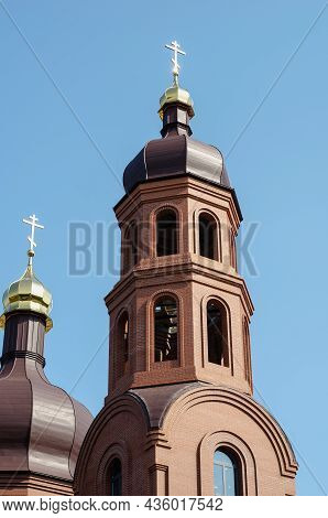 Red Brick Building Of The Christian Orthodox Church. New Building Under Construction In Front Of The