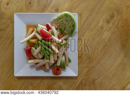 Lotus Stem Thai Spicy Salad On Wooden Table. Thai Som Tum With Lotus Stem Is Popular Thai Local Styl