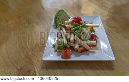 Lotus Stem Thai Spicy Salad On Wooden Table. Thai Som Tum With Lotus Stem Is Popular Thai Local Styl